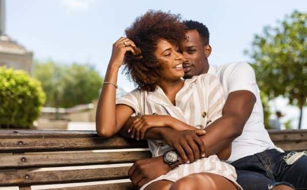 happy couple sitting on a bench